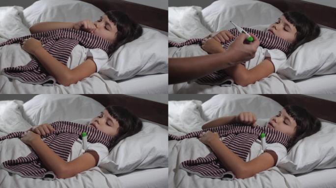 特写的小女孩6岁得了感冒躺在床上患流感。小孩咳嗽和打喷嚏，母亲的手检查她的体温，抚摸额头。4K