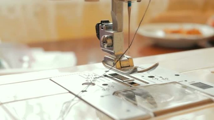 年轻的有爱心的家庭主妇使用缝纫机缝制衣服