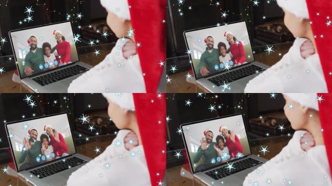 在与家人的笔记本电脑视频通话中，圣诞老人帽子中的白人女孩的圣诞明星动画