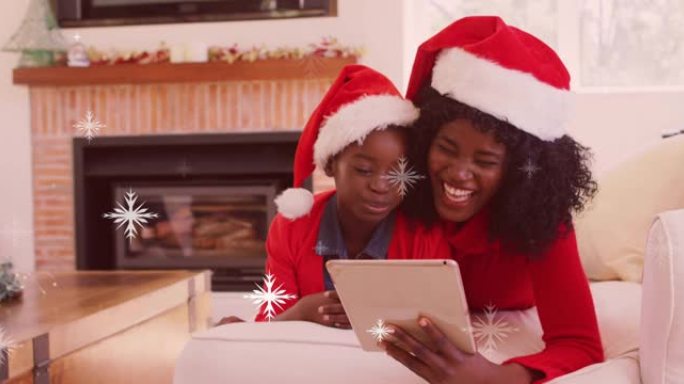 圣诞节用平板电脑降落在非裔美国母亲与儿子的积雪动画