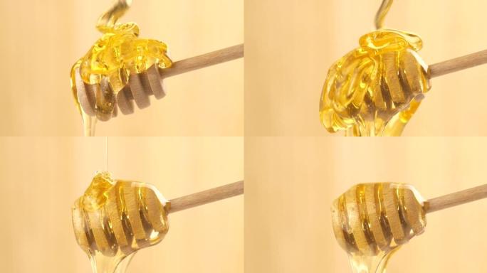 液体有机蜂蜜从上方在浅色背景上滴落在蜂蜜铲斗上。健康食品概念。金色蜂蜜从木勺中倒出和流出