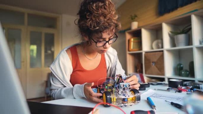 积极的自学成才的女性程序员，使用开源硬件和软件平台，改进了她的带传感器的机器人汽车原型