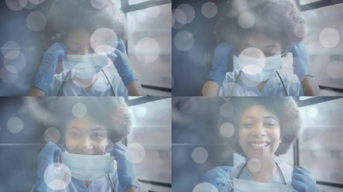戴着口罩的微笑的非洲裔美国女医生身上发光斑点的动画