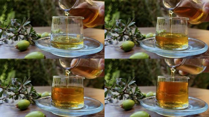 摩洛哥坚果油正在倒入玻璃瓶中。这种纯净、正宗的有机摩洛哥坚果油是摩洛哥妇女手工生产的。