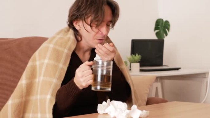 男人生病了，坐在家里，染上病毒，感冒和流感，冠状病毒。家庭隔离，一个人打喷嚏和咳嗽。高发热，治疗，病