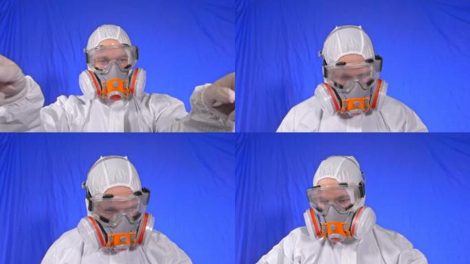 呼吸器中的疯狂科学病毒学家。慢动作。男子近距离看，戴着防护医用口罩。新型冠状病毒肺炎。色度键蓝色电影
