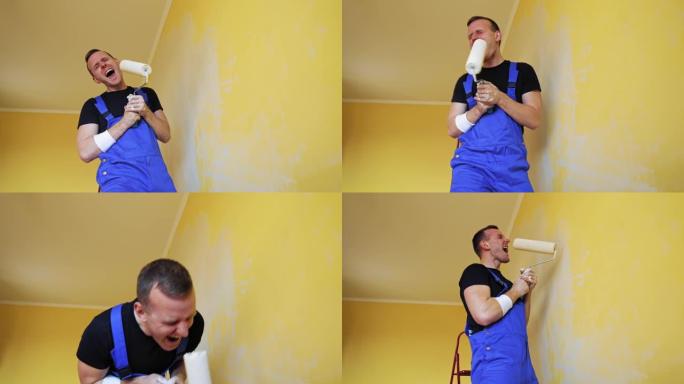 带着油漆滚筒的快乐画家。穿着蓝色工作服的有趣的年轻人工人一边粉刷墙壁一边唱着滚轴。房子里改头换面的快