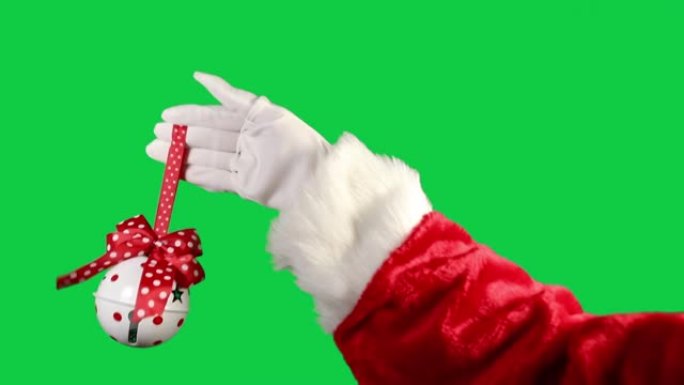 圣诞老人的手在绿色背景上响起圣诞节叮当铃