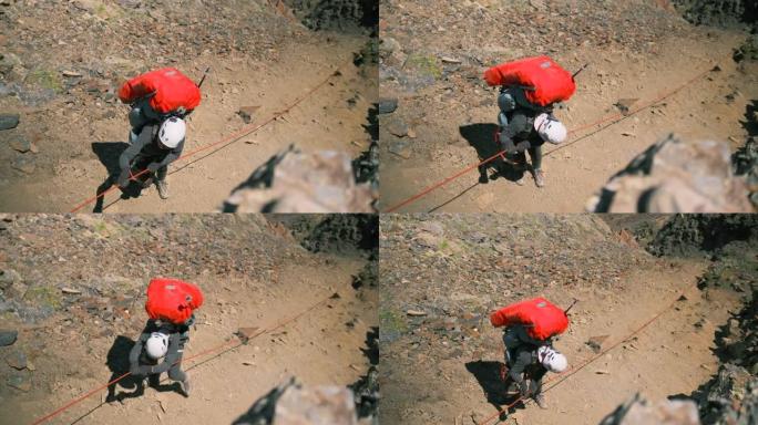 背着背包准备从悬崖上掉下来的女人。