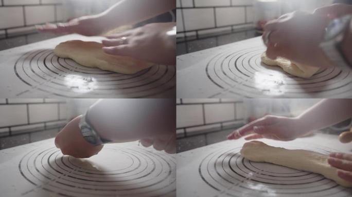 糕点厨师用手在白板上揉捏自制软面团面粉，准备在厨房做面包面包店