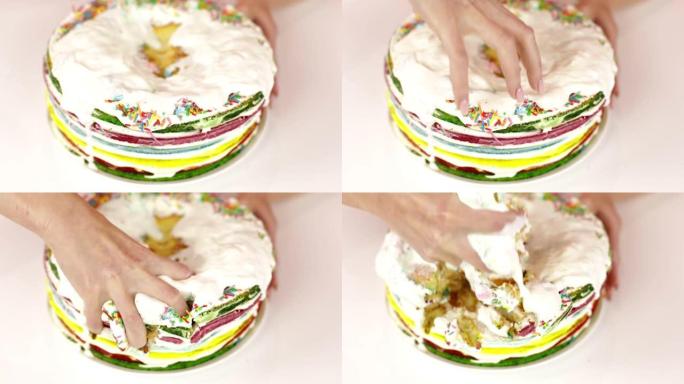 双手撕碎蛋糕的特写镜头。
