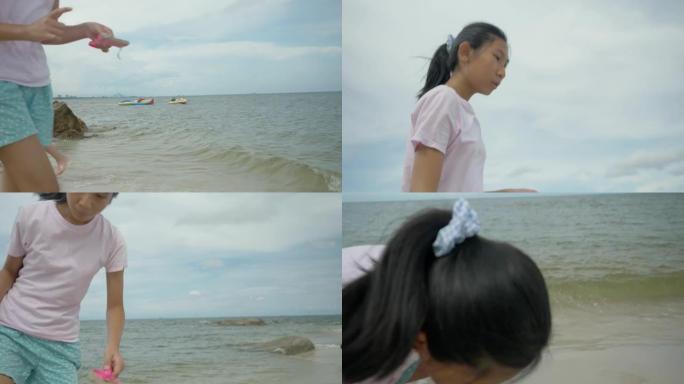 快乐的亚洲儿童在阳光明媚的日子里一起在海滩上放松，生活方式理念。