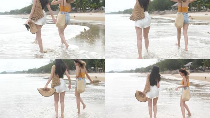 两个女人在假期享受快乐地在海滩上跑步