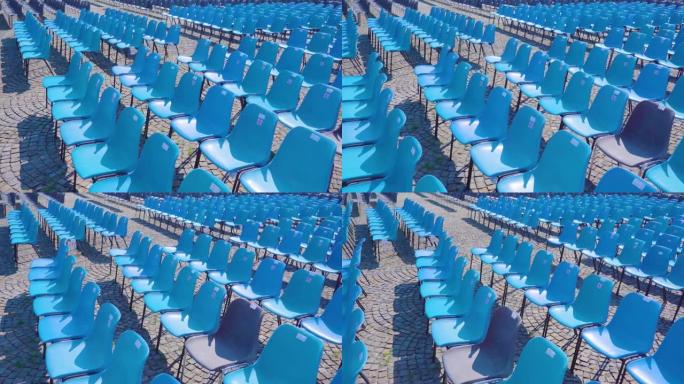 蓝色塑料椅子排成一排，用于观察事件