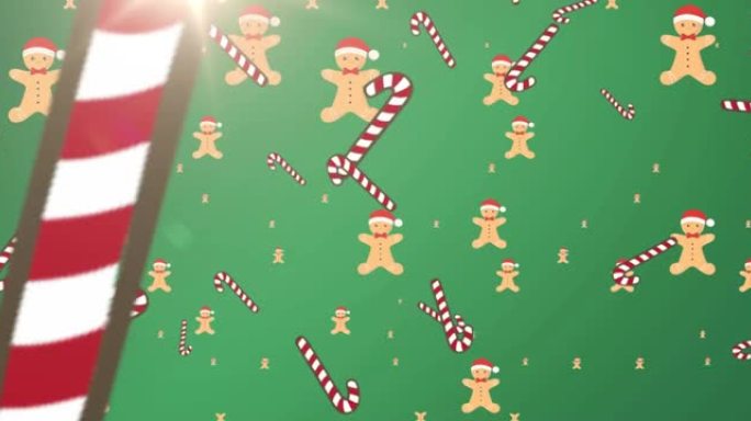 绿色背景上掉落的圣诞手杖和饼干的动画