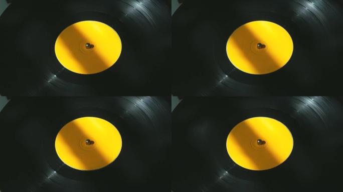 旧DJ转盘播放器上带有黄色标签的黑色乙烯基复古唱片旋转板。派对和流行迪斯科趋势上的老式旋转唱片特写。