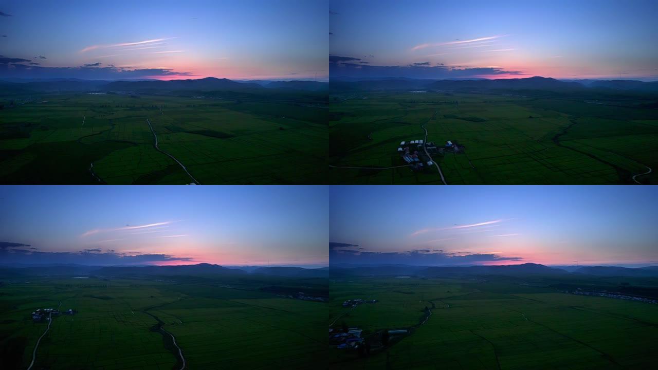一个小村庄的无人机鸟瞰图。日落时的稻谷植物田