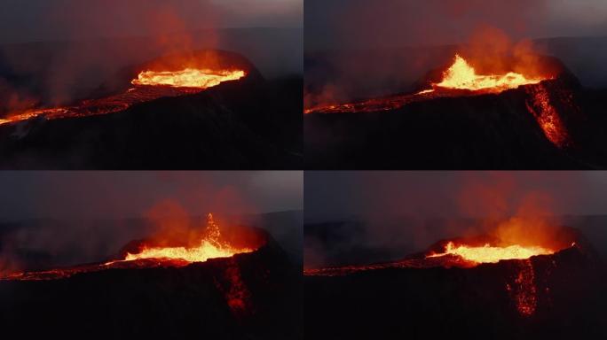 沸腾的岩浆物质从火山口溅出。发光的熔岩照亮流出的气体。热熔岩流。法格拉达尔斯福杰尔火山。冰岛，202