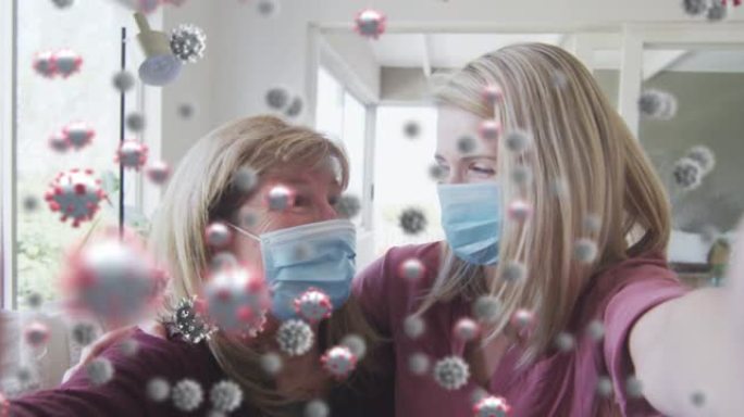 新型冠状病毒肺炎细胞对抗白人母亲和女儿戴着口罩在家里微笑