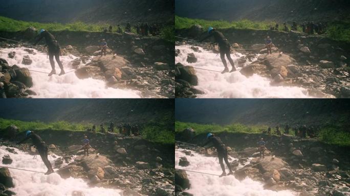 一名游客在绳索形式的垂直绳索的帮助下过河，用登山扣固定。
