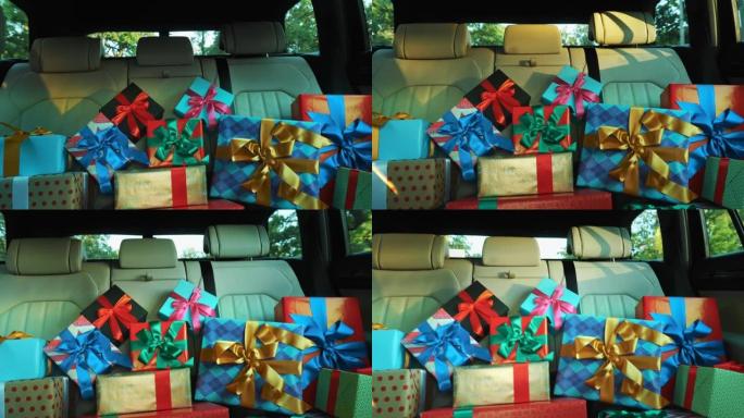 汽车中的礼品盒。送货。捐赠，慈善。许多包装精美的包裹，盒子，躺在汽车后座上，在阳光下。特写，从车内观