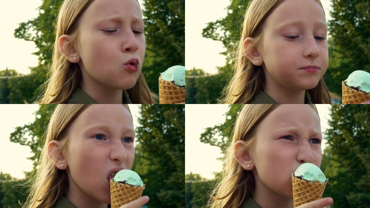 金发少女在周日集市上咬了一个冰淇淋蛋卷华夫饼蛋卷。青少年周末的有趣生活