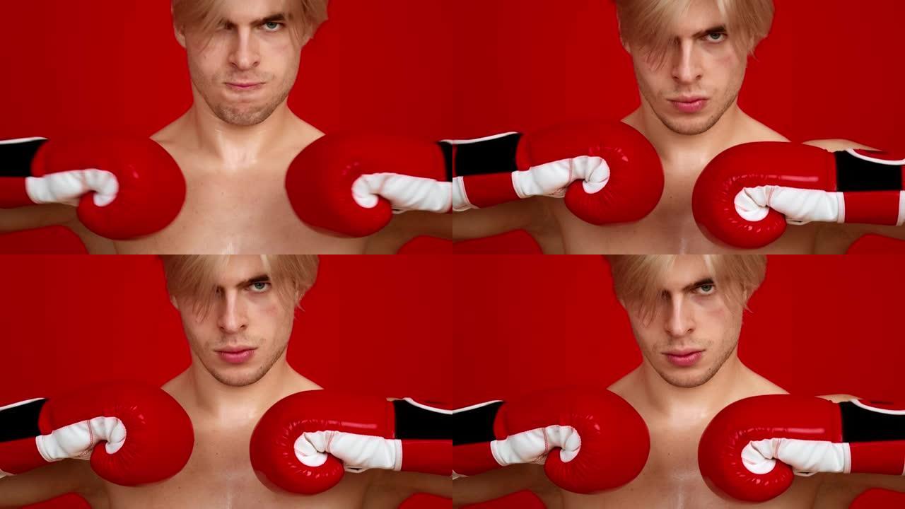 准备战斗。激进男子拳击手的特写肖像一起拳打他的拳击手套，愤怒地看着镜头