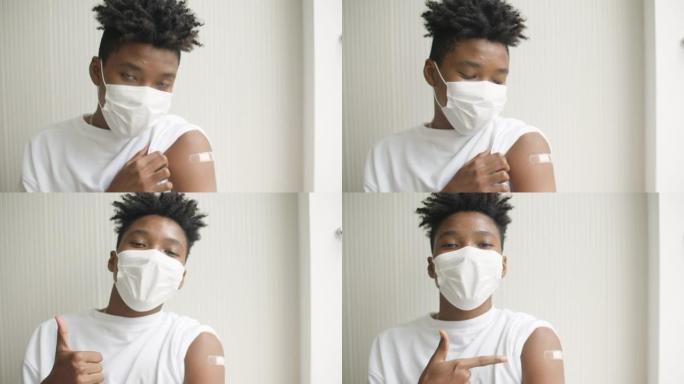 一名非洲裔美国青少年在接种疫苗并在手臂上露出绷带后竖起大拇指的肖像