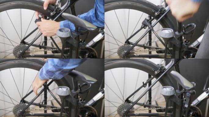 自行车机械师给自行车车轮充气。骑自行车的人将空气泵入自行车车轮轮胎。修理自行车车间