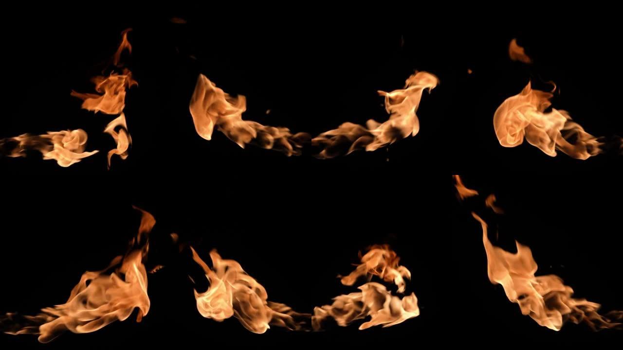黑暗中，两场火焰从屏幕的不同侧面燃烧。真正的篝火、燃烧器或火炬在黑色背景下闪烁。高速喷火器随火焰爆炸