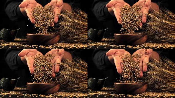 黑麦谷物的超慢动作从碗里的男人手中掉下来。以1000 fps的高速相机拍摄。