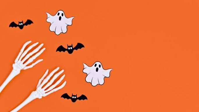 鬼魂和蝙蝠绕着骷髅手飞翔。万圣节停止运动