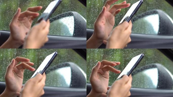 在汽车中使用智能手机的特写女性。