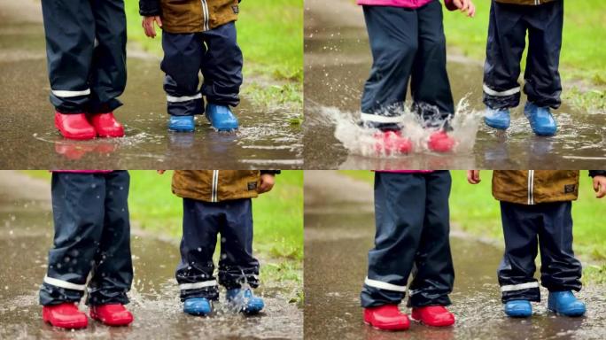 穿着橡胶靴和防水裤的顽皮孩子在雨水坑中跳跃。慢动作