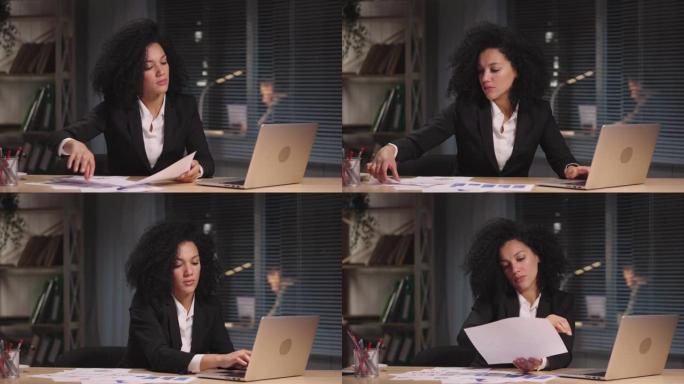 非裔美国妇女的肖像正在查看构成报告的图表。女商人在工作场所摆姿势，坐在办公室内部的桌子旁。慢动作准备