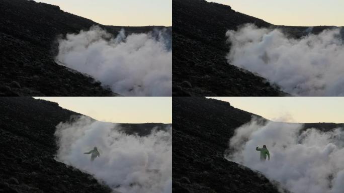 人类从fagradarsfjall火山爆发的熔岩流烟雾中冒出来