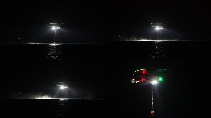 夜视消防直升机从海上取水。