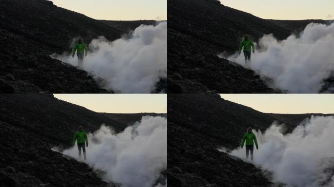 人类从fagradarsfjall火山爆发的熔岩流烟雾中冒出来