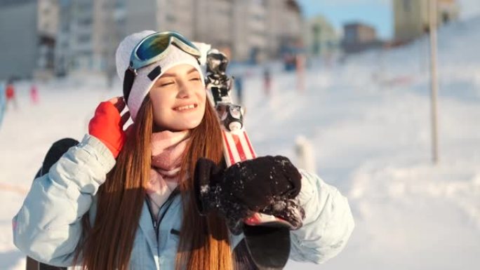 美丽的年轻欧洲妇女在滑雪胜地的设备