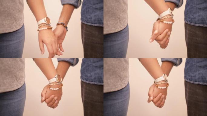 相爱的年轻夫妇紧握着彼此的手