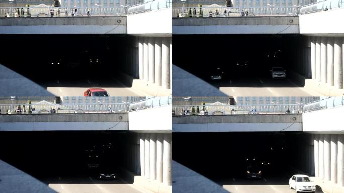 乌克兰基辅-2021年4月24日: 汽车驶出隧道。楼上有游客步行广场