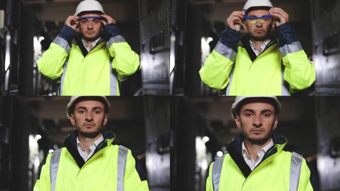 专业的重工业工程师工人穿着制服，戴着眼镜和安全帽在钢铁厂看着相机。站在金属建筑制造商中的高加索工业专