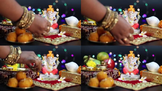 已婚女孩戴着手镯，在印度教神领主甘尼萨·甘帕蒂·巴帕·莫里亚面前深深地敬拜新年迪帕瓦里