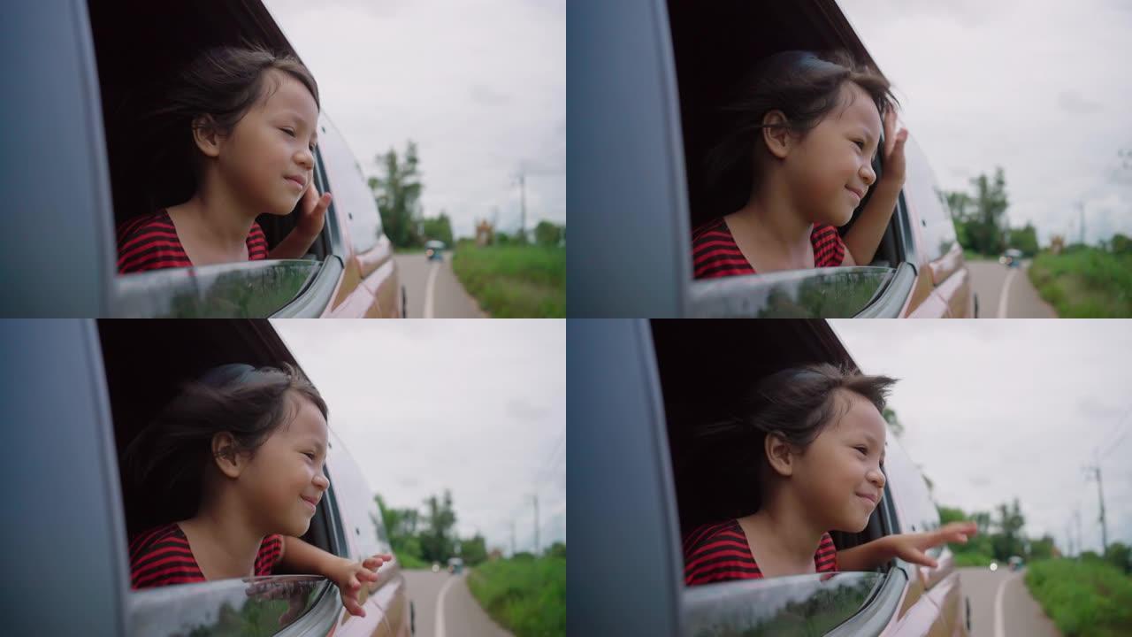 可爱的女孩从车窗上看时感到精神焕发