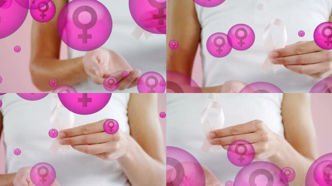 动画的女性符号在粉红色的泡泡与手握乳腺癌丝带的女人，在粉红色