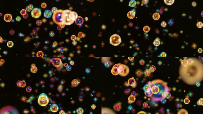 许多彩虹明亮的肥皂泡在黑色背景上飞来飞去。彩色圆形气泡以慢动作在空间中移动，并在光线中闪烁。特写