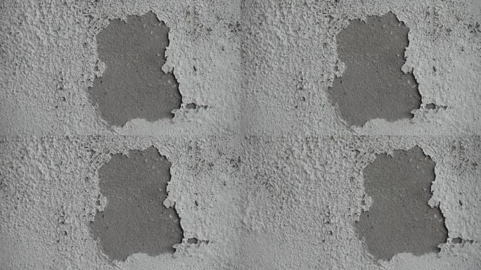 白色潮湿的墙壁显示油漆开裂，破裂或剥落。墙壁上脆弱的白色衬里。抽象的破裂和肿胀的黑白背景。宏特写视图