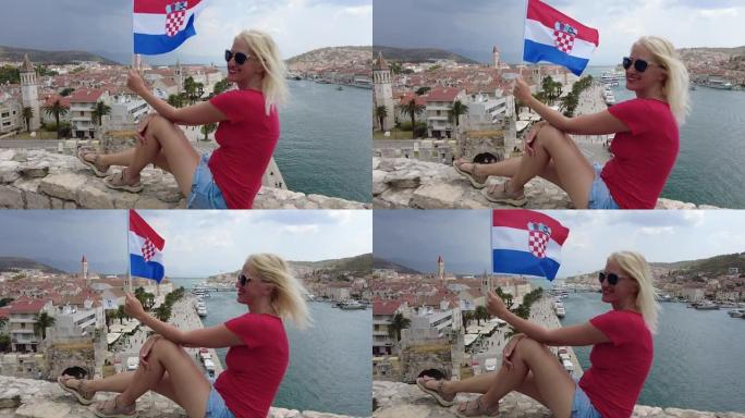 女人在特罗吉尔挥舞着克罗地亚国旗