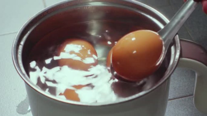 拿起鸡蛋在电锅上留下开水