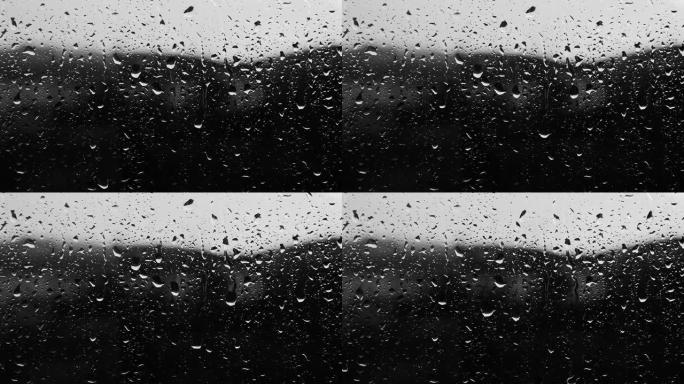 黑色和白色阴影的雨框，玻璃上的雨的背景